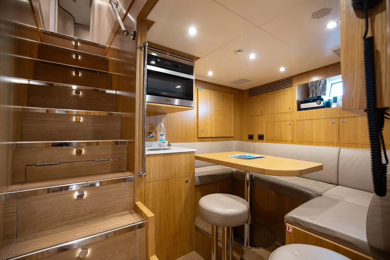 a kitchen with wooden cabinets aboard ABBENTURES III Yacht for Sale