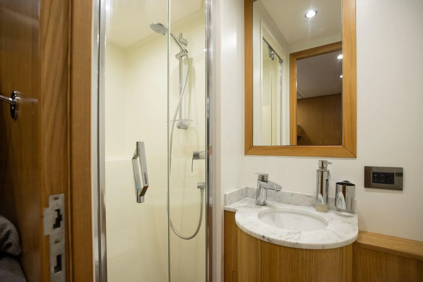 a bathroom with a glass shower door aboard ABBENTURES III Yacht for Sale