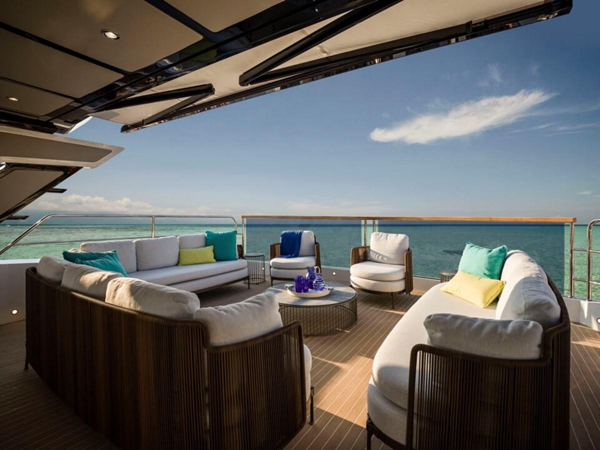 a large lounge area with a pool aboard 90 OCEAN Yacht for Sale