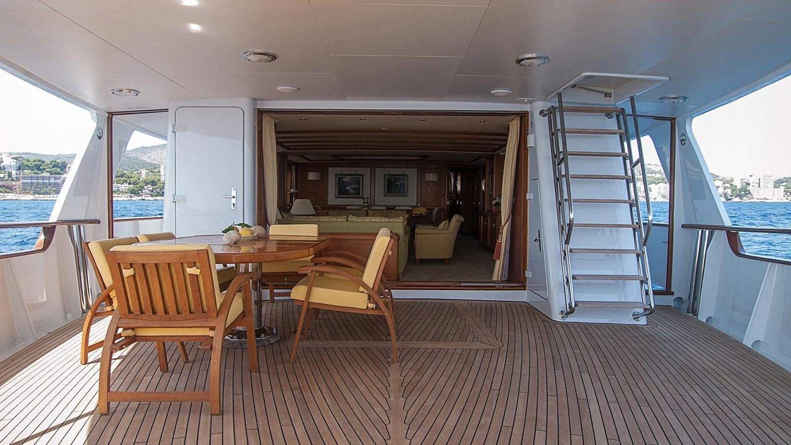 a large open house with a dining table and chairs aboard LA REINA DEL MAR Yacht for Sale