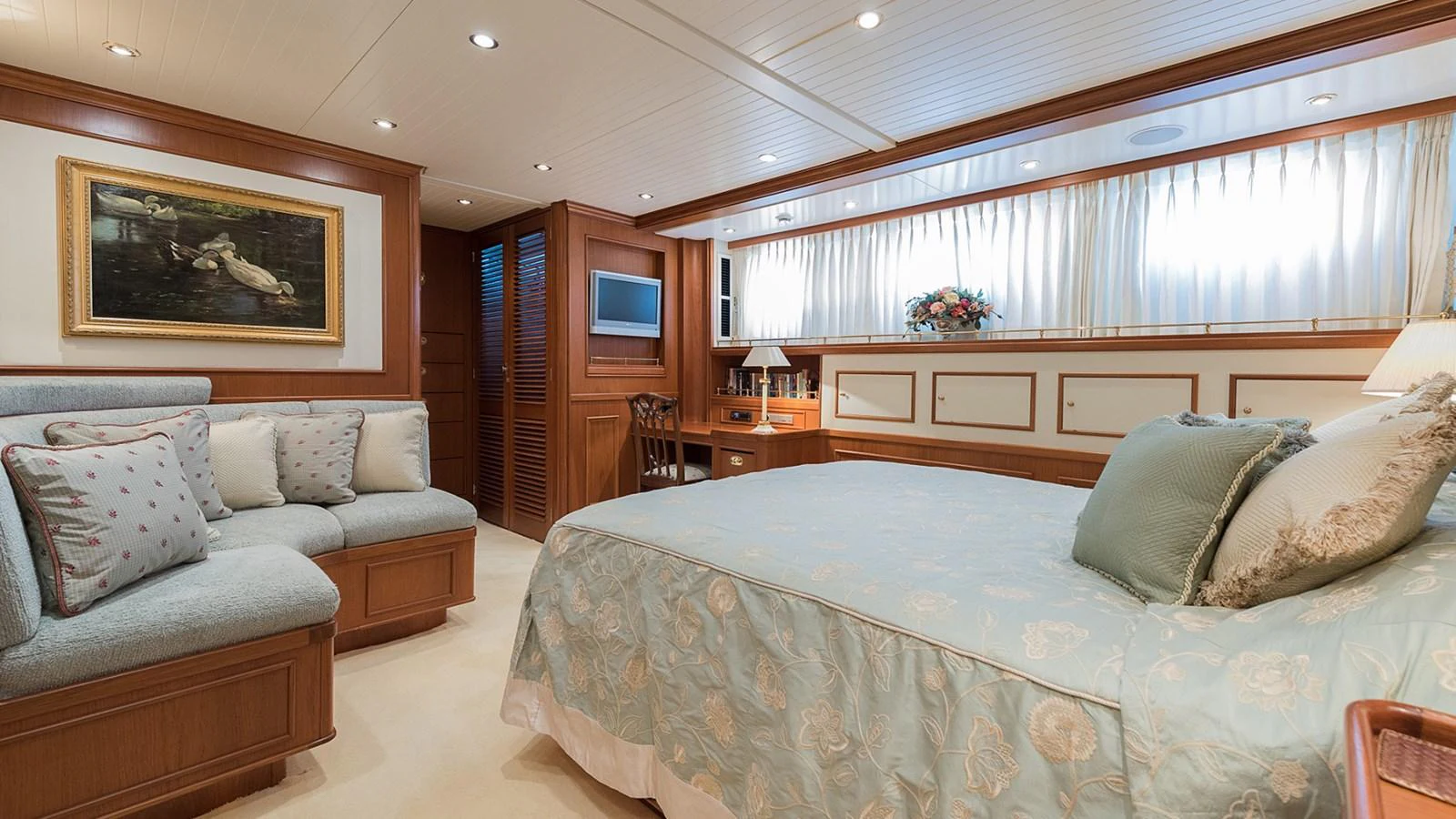 a bedroom with a bed and a couch aboard LA REINA DEL MAR Yacht for Sale