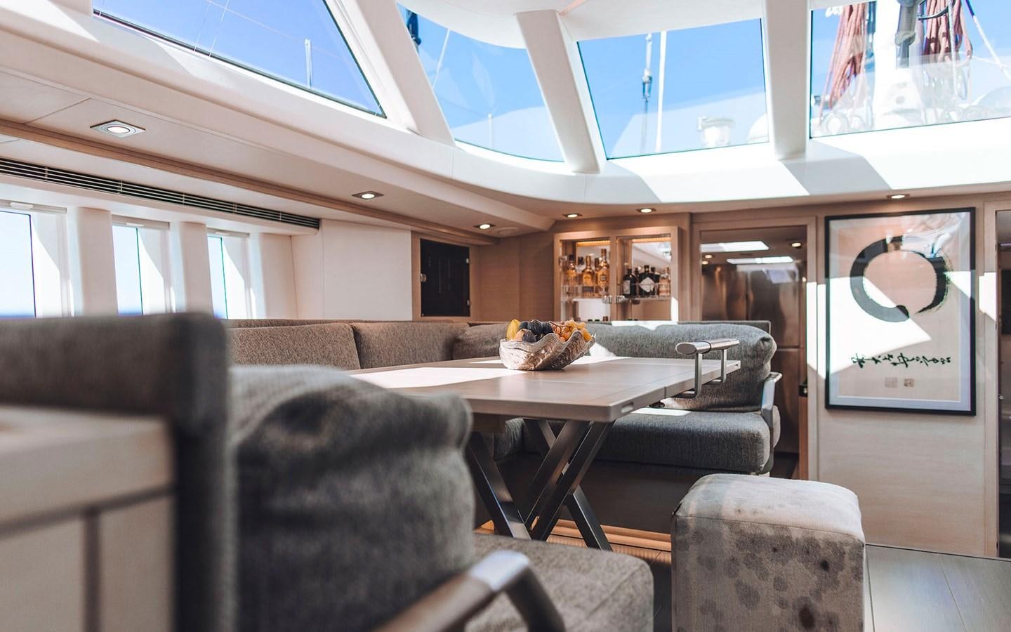 a room with a couch and a table aboard ENSO Yacht for Sale