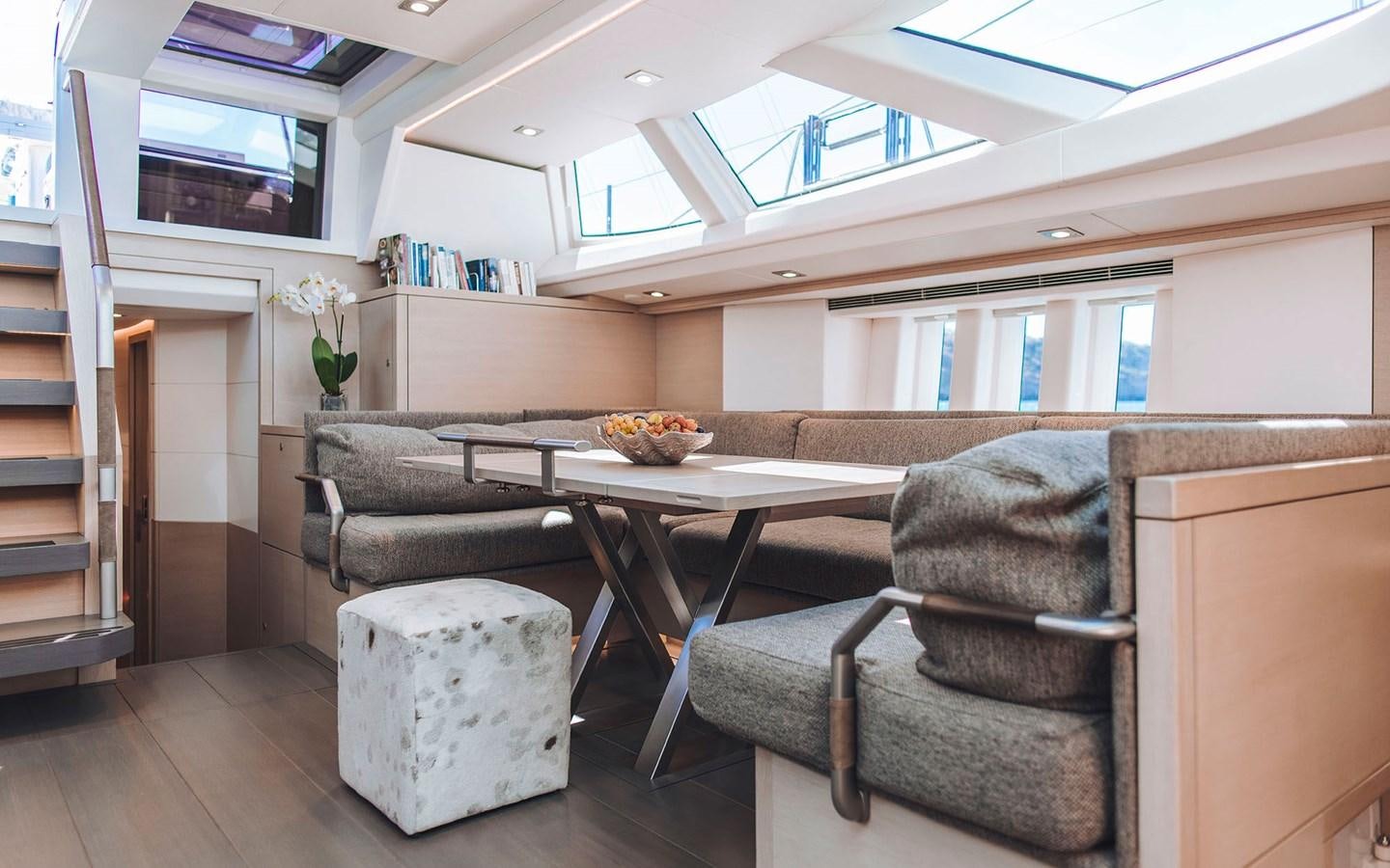 a living room with a table and chairs aboard ENSO Yacht for Sale