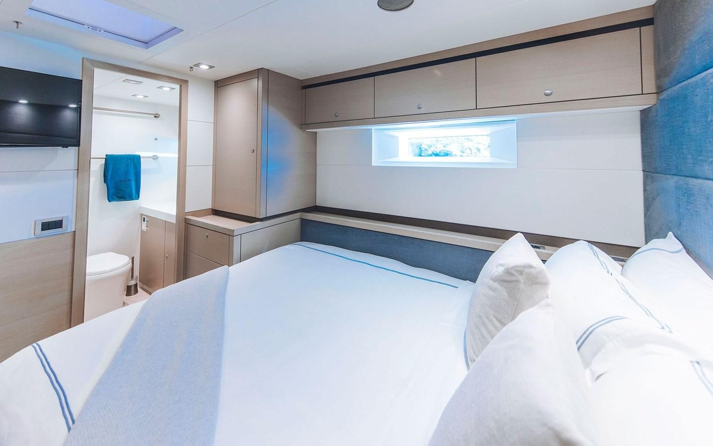 a room with a bed and cabinets aboard ENSO Yacht for Sale