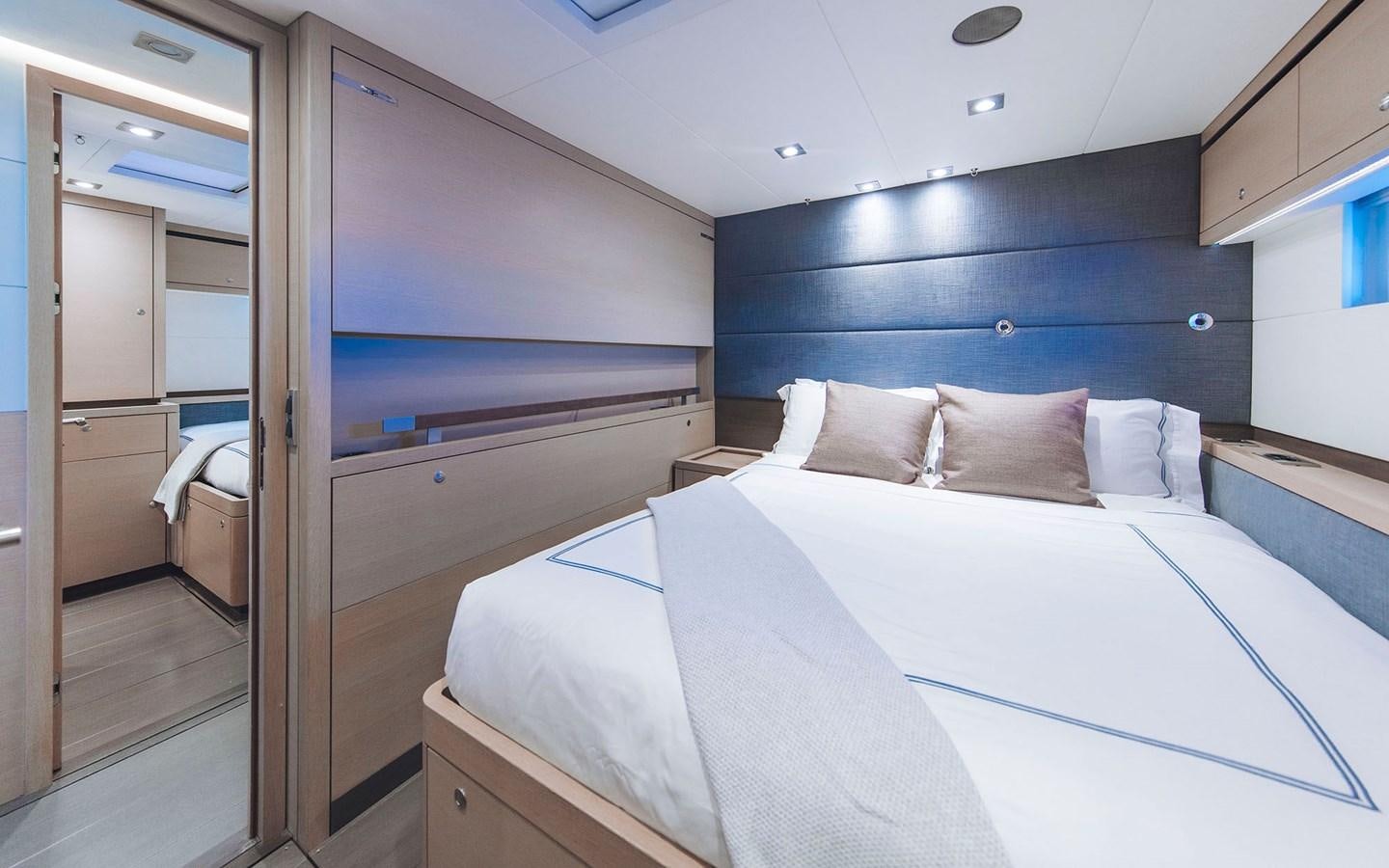 a room with a bed and a mirror aboard ENSO Yacht for Sale