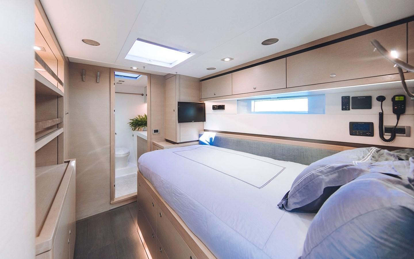 a room with a bed and a tv aboard ENSO Yacht for Sale