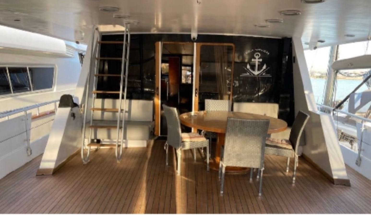 a room with a table chairs and a ladder aboard SEA SEVEN Yacht for Sale