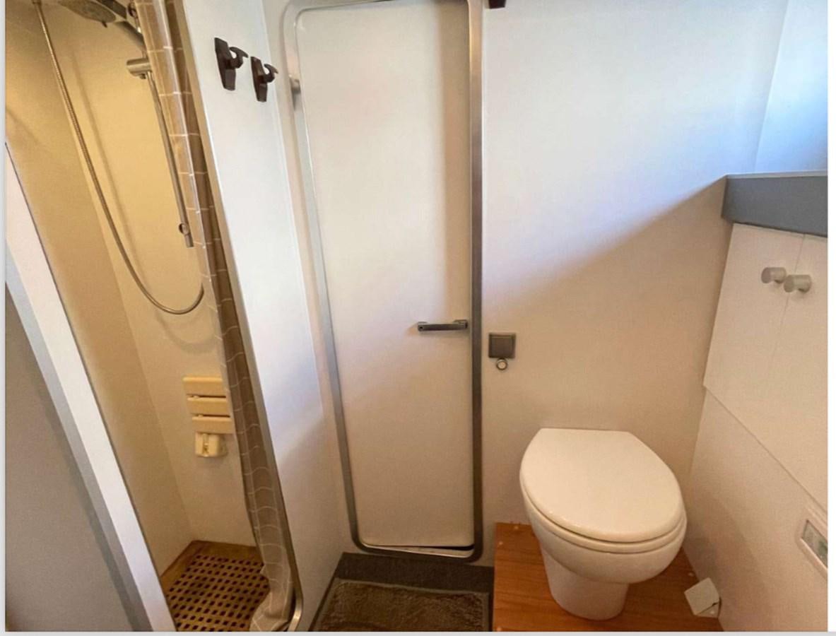 a bathroom with a toilet and a shower aboard SEA SEVEN Yacht for Sale