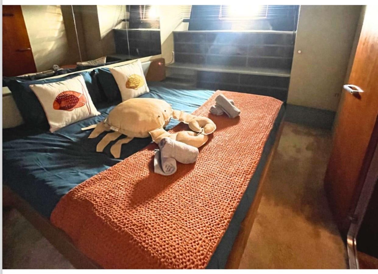 a bed with a stuffed animal aboard SEA SEVEN Yacht for Sale