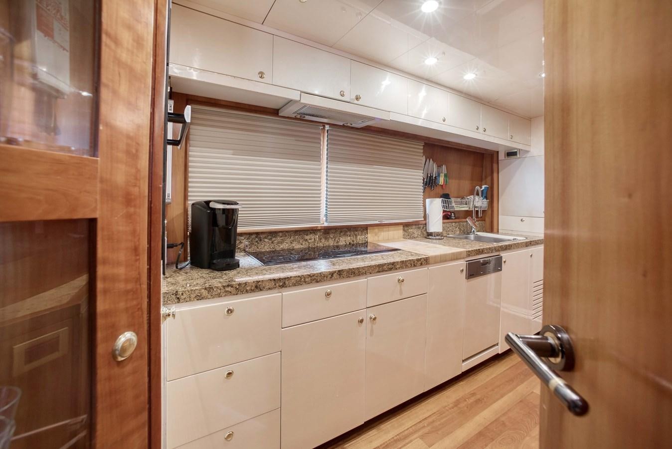 a kitchen with a black coffee mug on the counter aboard BLUE SYMPHONIE Yacht for Sale