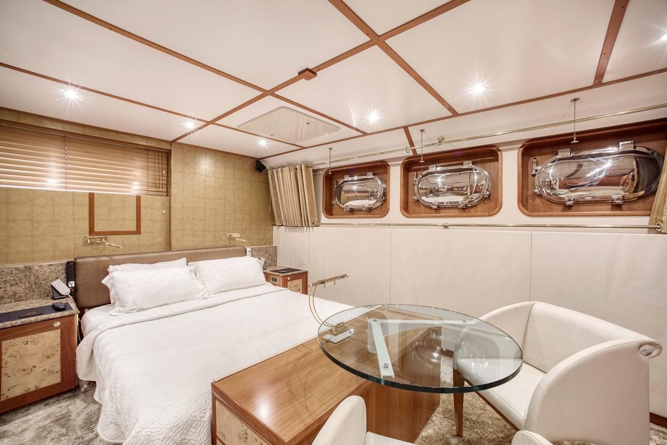 a room with a bed and a table aboard BLUE SYMPHONIE Yacht for Sale