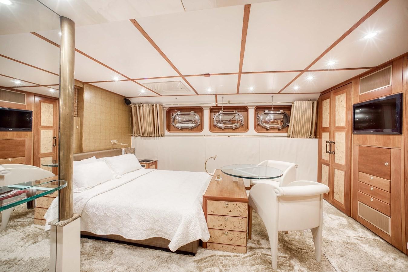a bedroom with a bed and a table aboard BLUE SYMPHONIE Yacht for Sale