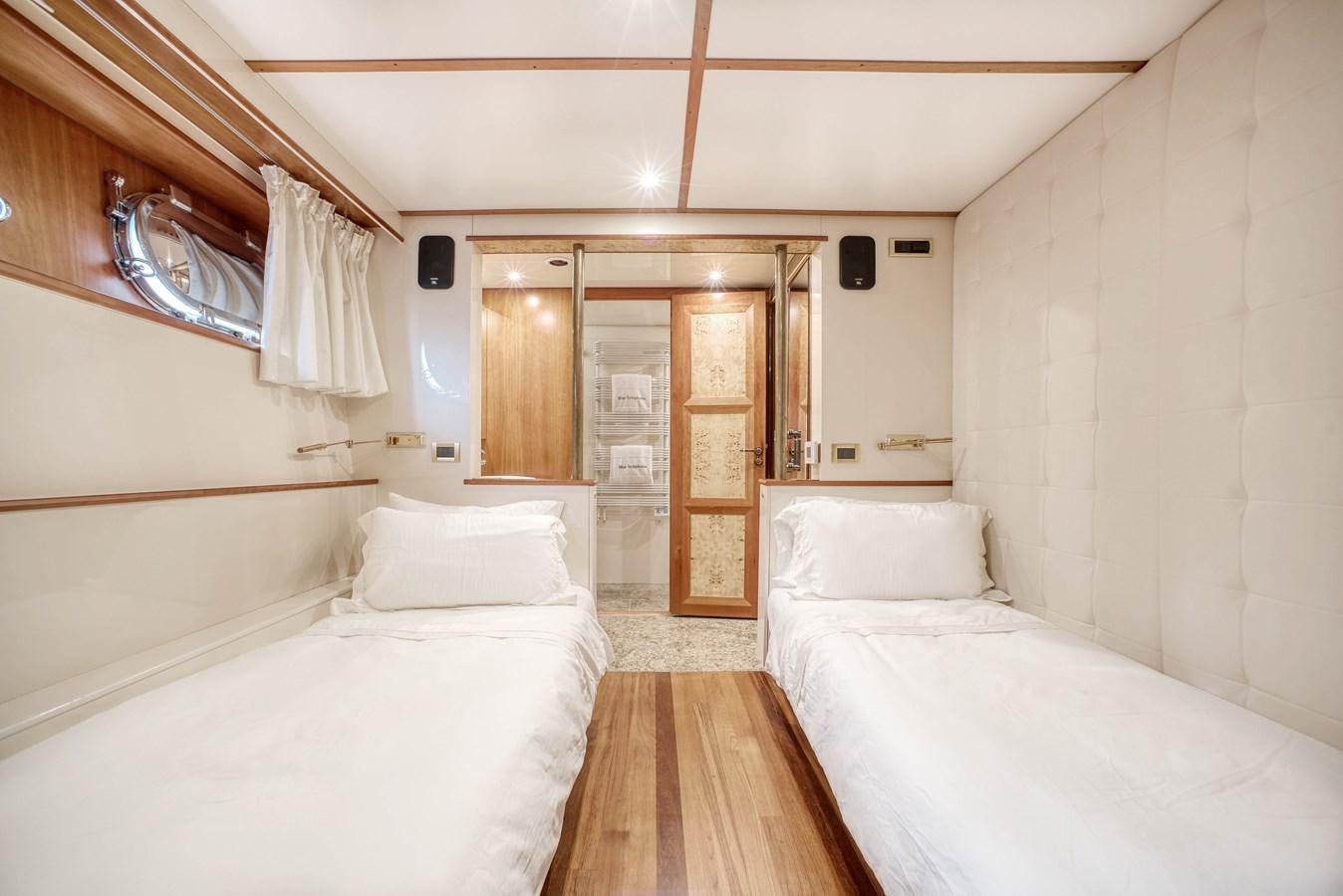 a room with a bed and a door aboard BLUE SYMPHONIE Yacht for Sale