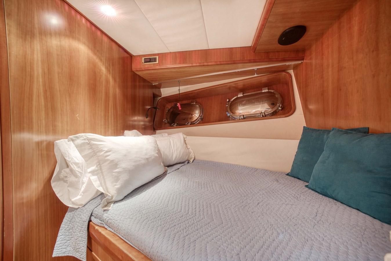 a bed with a white sheet and a white pillow aboard BLUE SYMPHONIE Yacht for Sale