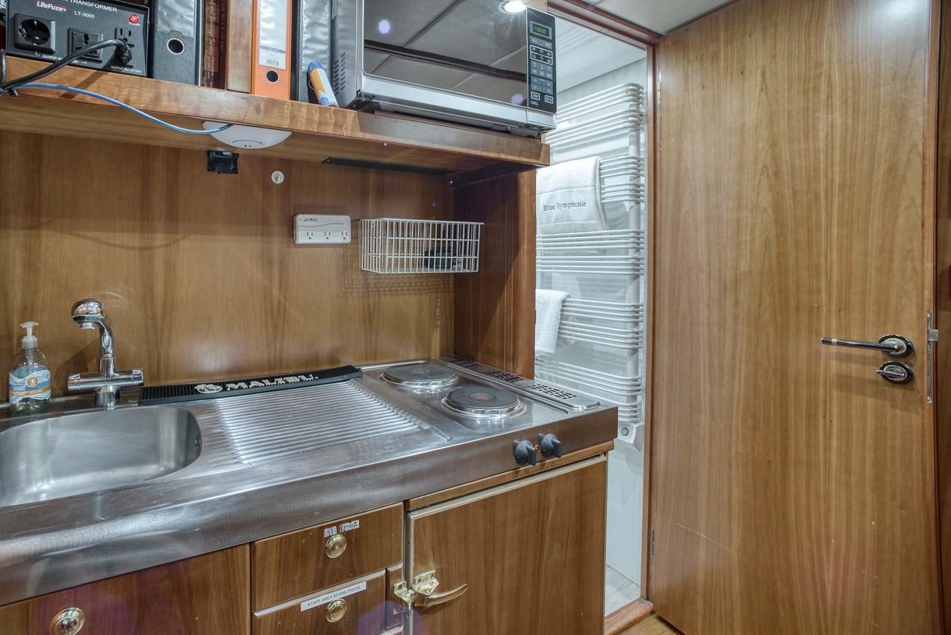 a kitchen with a sink and a microwave aboard BLUE SYMPHONIE Yacht for Sale