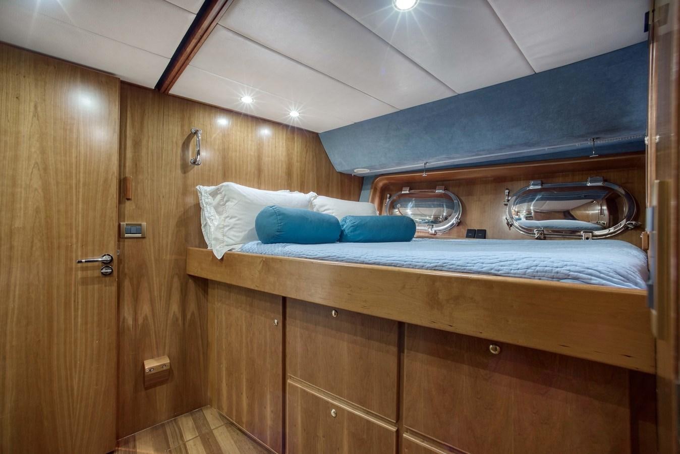 a bed in a wooden room aboard BLUE SYMPHONIE Yacht for Sale
