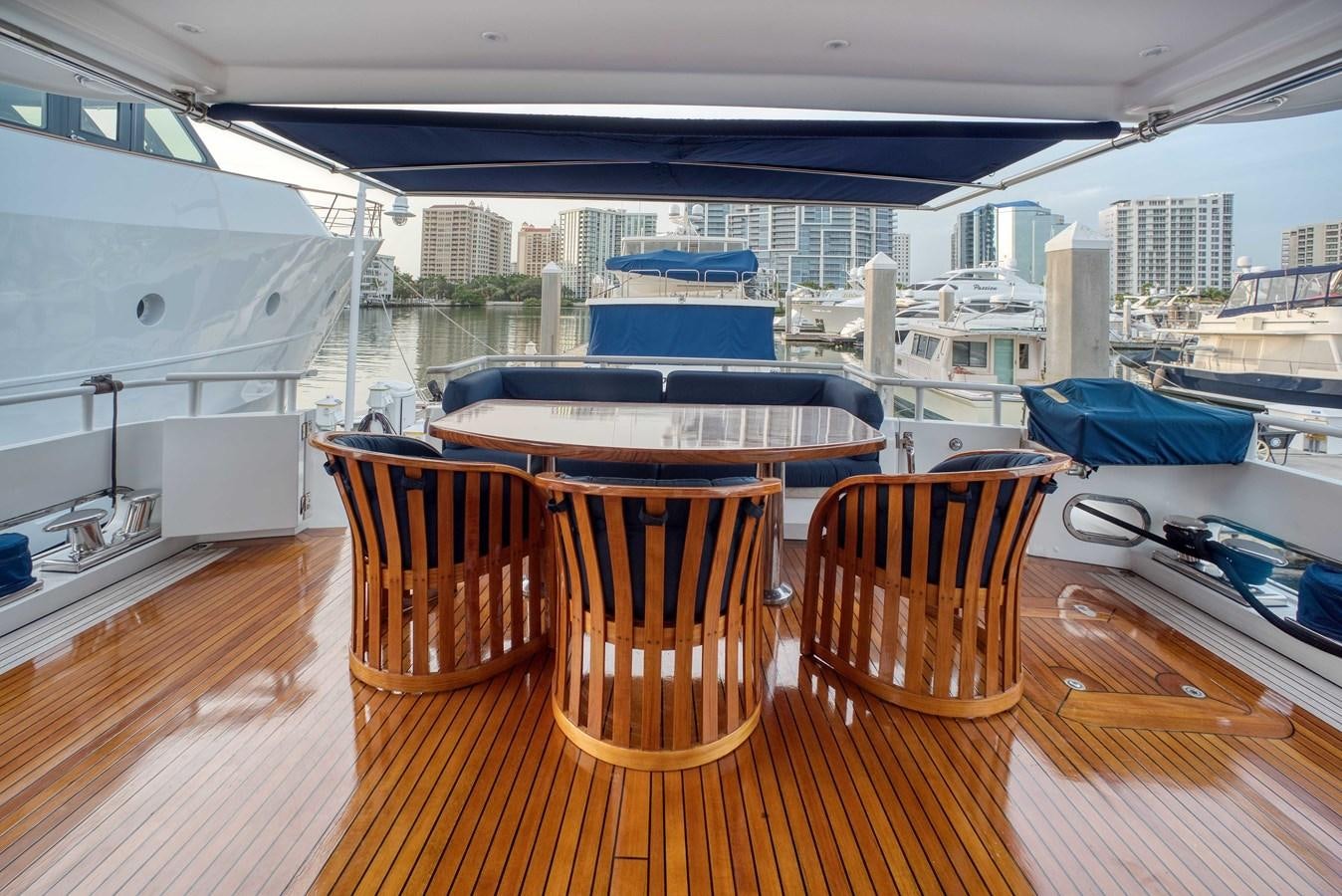 a deck with chairs and tables on it aboard BLUE SYMPHONIE Yacht for Sale