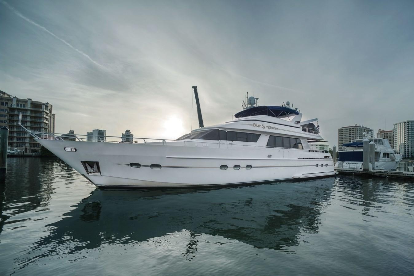 a white yacht in the water aboard BLUE SYMPHONIE Yacht for Sale