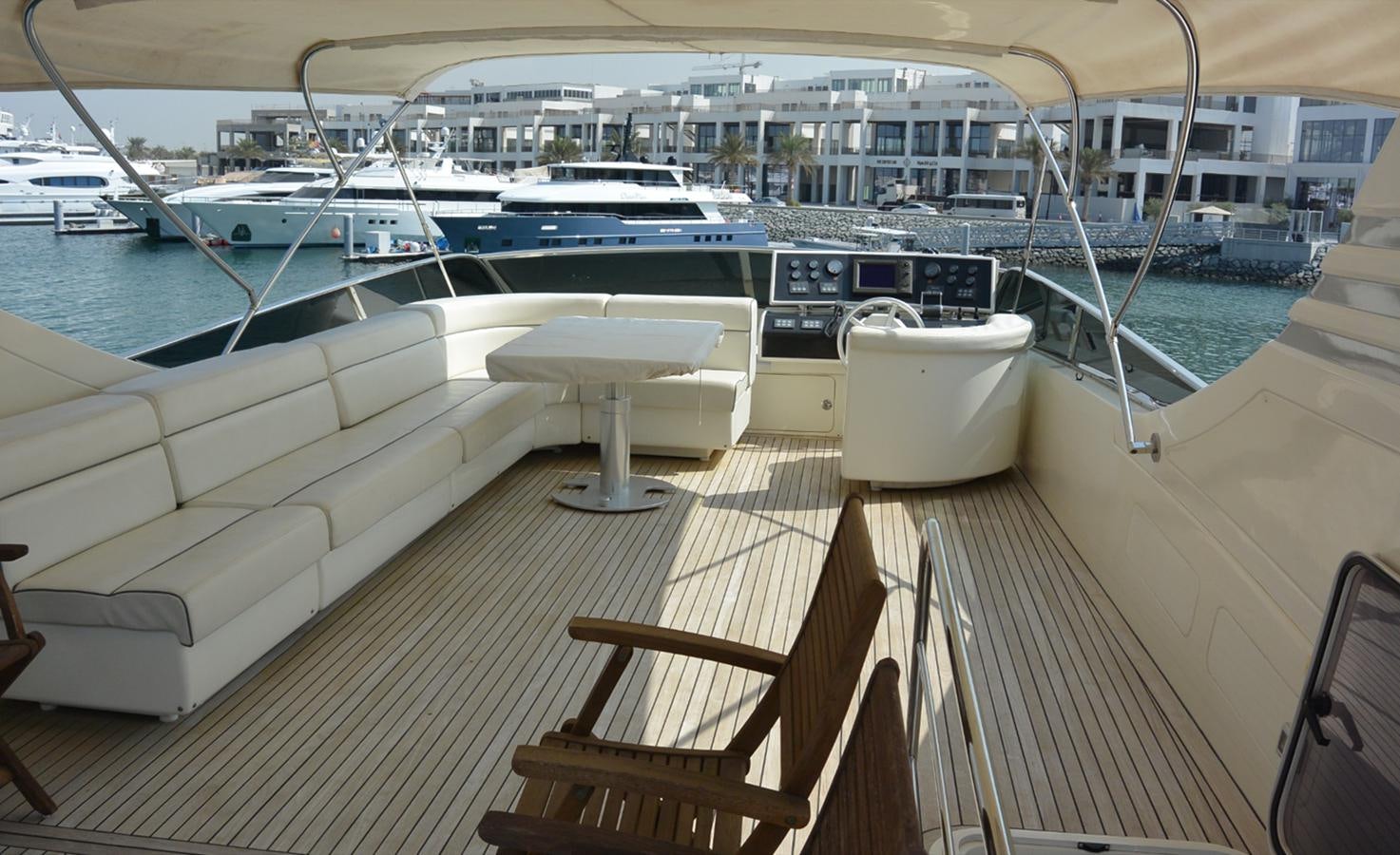 a deck with a boat and a bench on it aboard 2008 CANADOS 76 Yacht for Sale