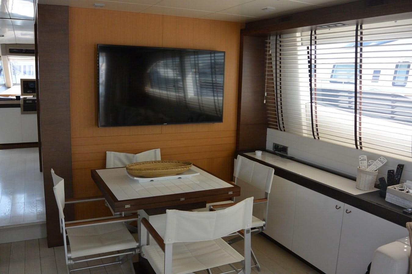 a kitchen with a table and chairs aboard 2008 CANADOS 76 Yacht for Sale