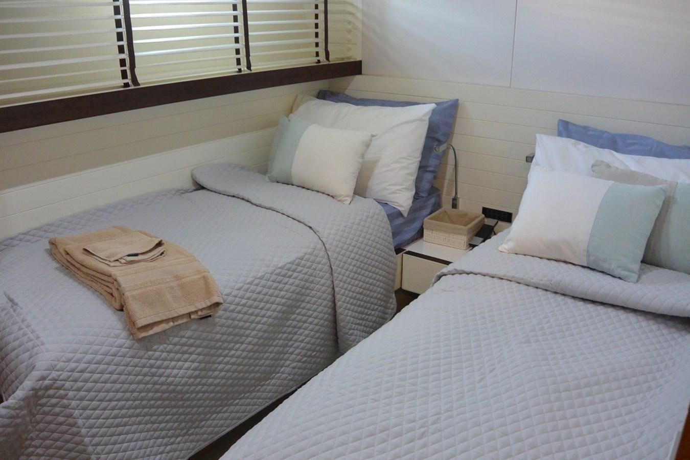 a couple of beds in a room aboard 2008 CANADOS 76 Yacht for Sale