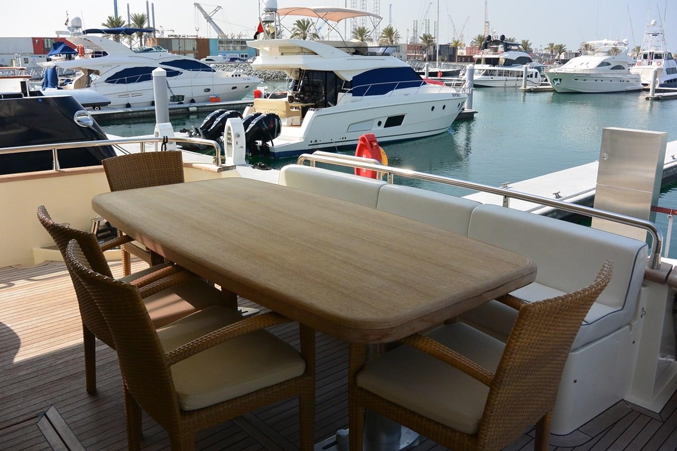 a table and chairs on a deck aboard 2008 CANADOS 76 Yacht for Sale