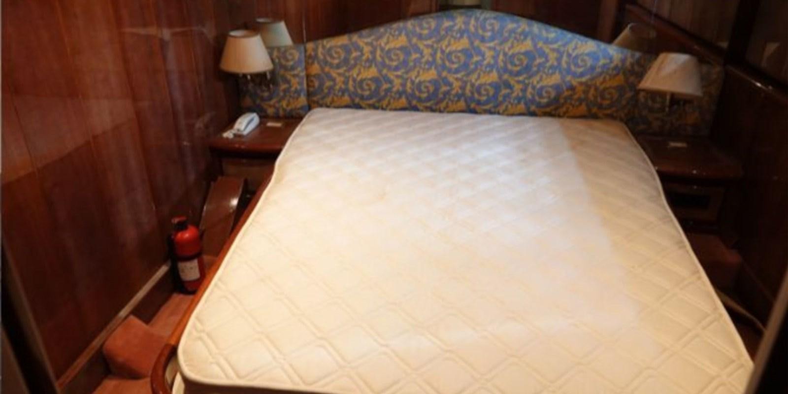 a bed with a blue and white comforter aboard DAN SHOW Yacht for Sale