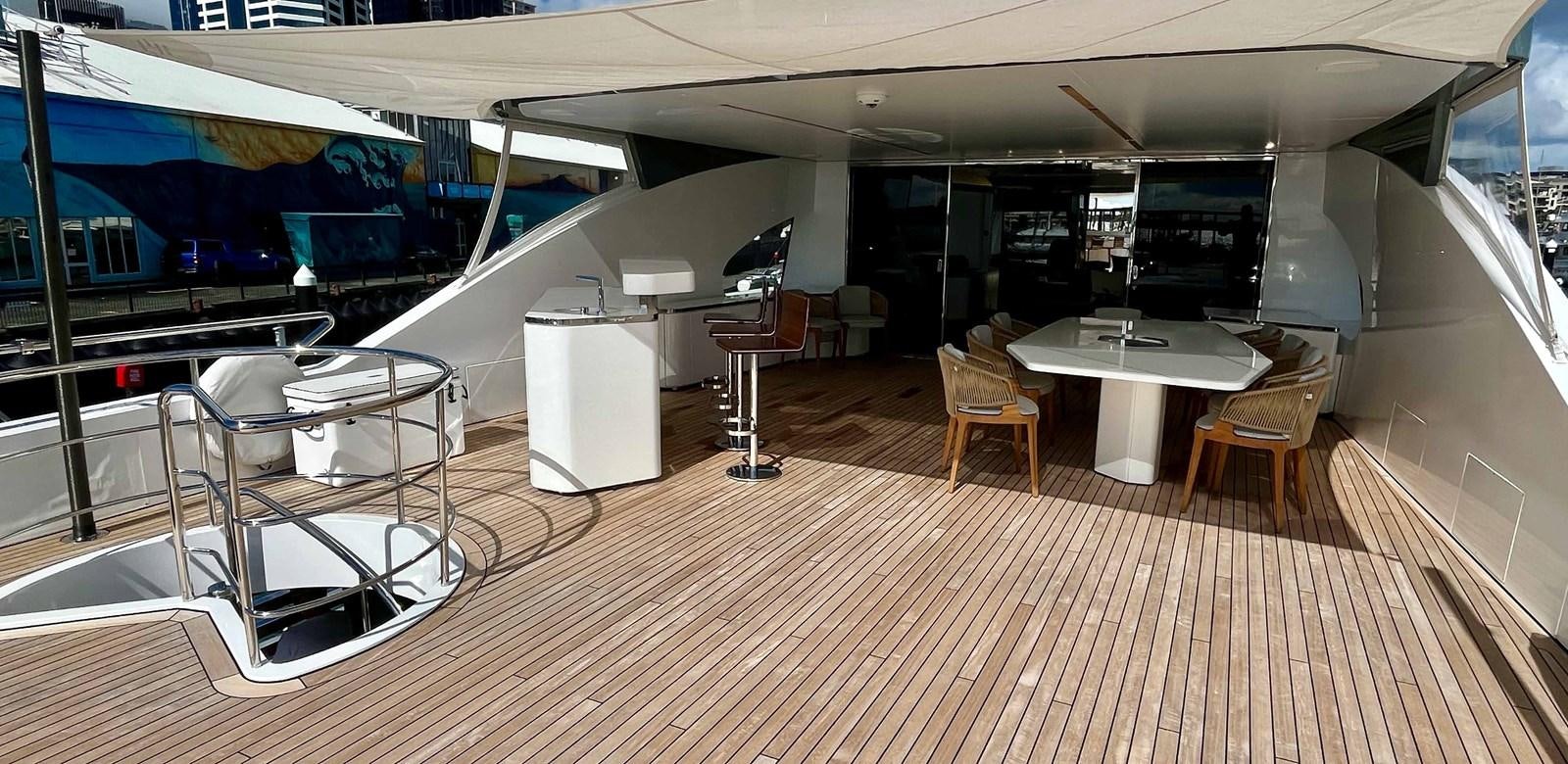 a room with tables and chairs aboard DB Yacht for Sale
