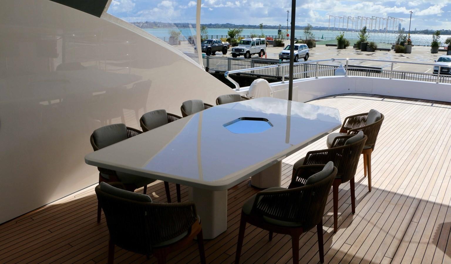 a table with chairs around it aboard DB Yacht for Sale