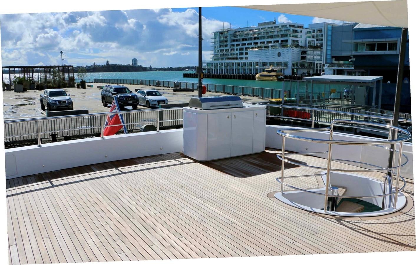 a deck with a boat and cars on it aboard DB Yacht for Sale