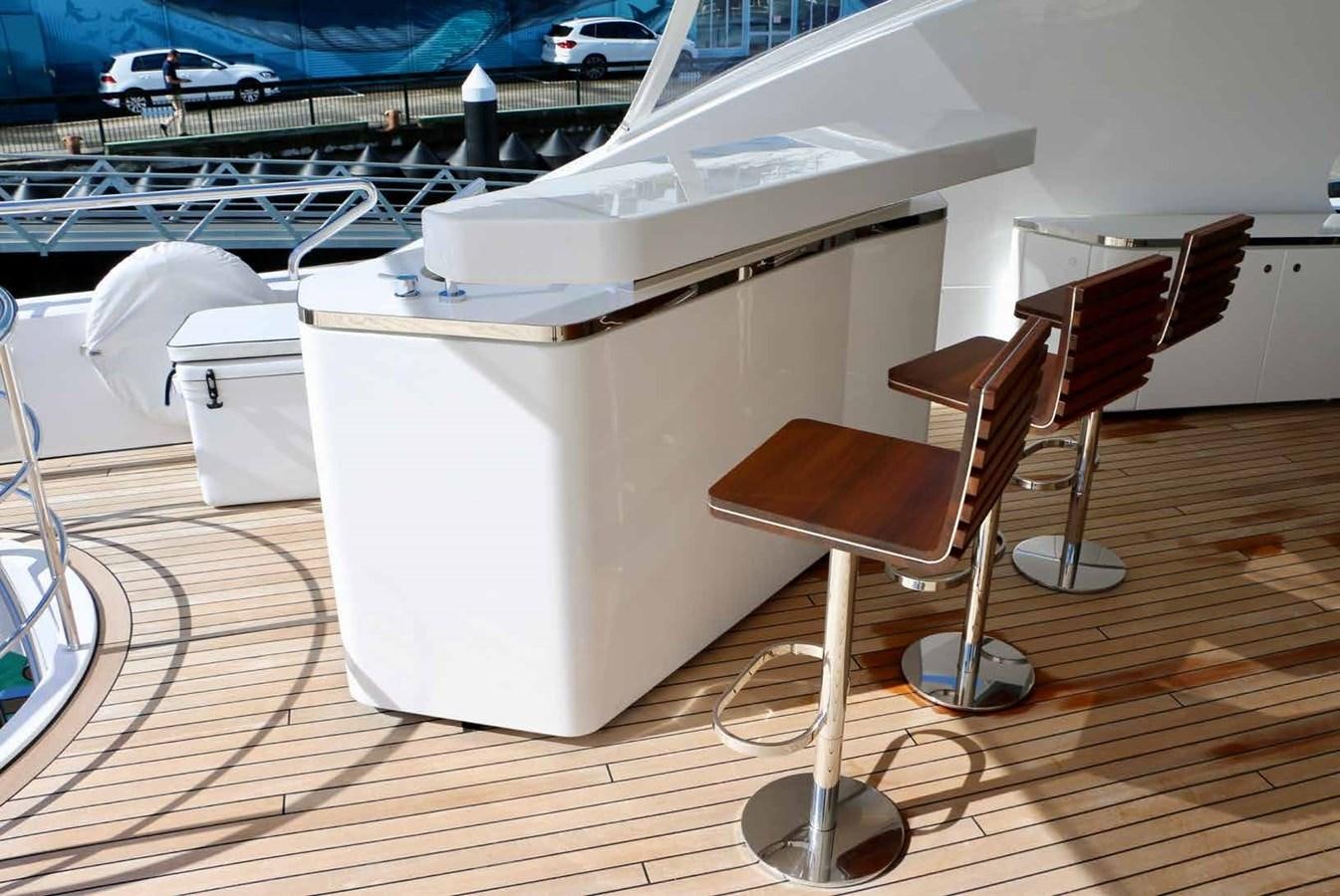 a white piano on a wooden floor aboard DB Yacht for Sale