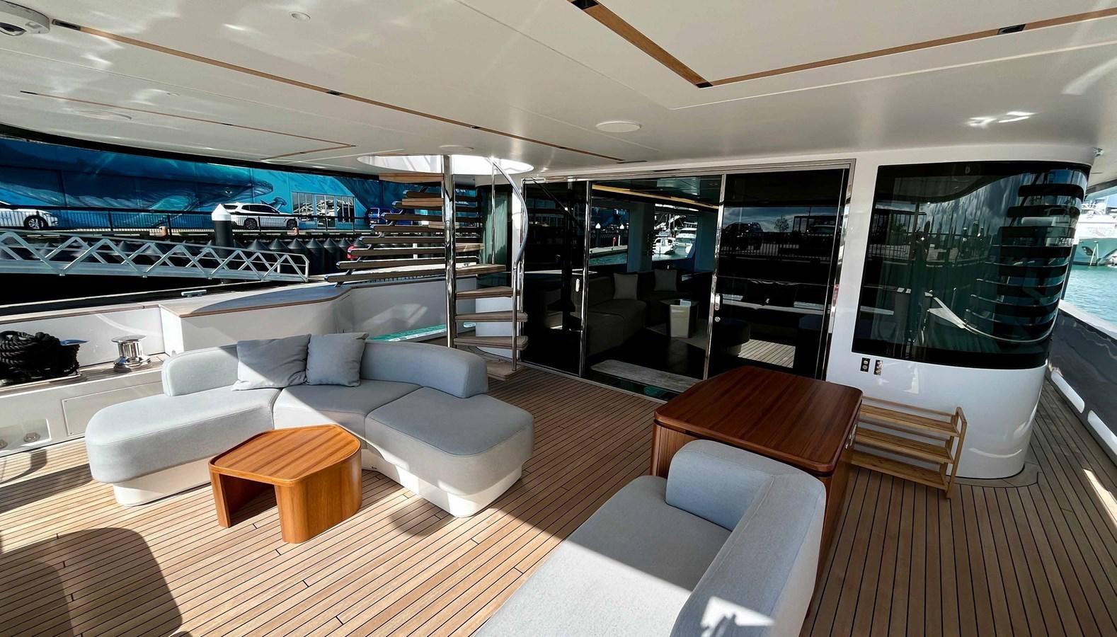 a living room with a large glass wall aboard DB Yacht for Sale