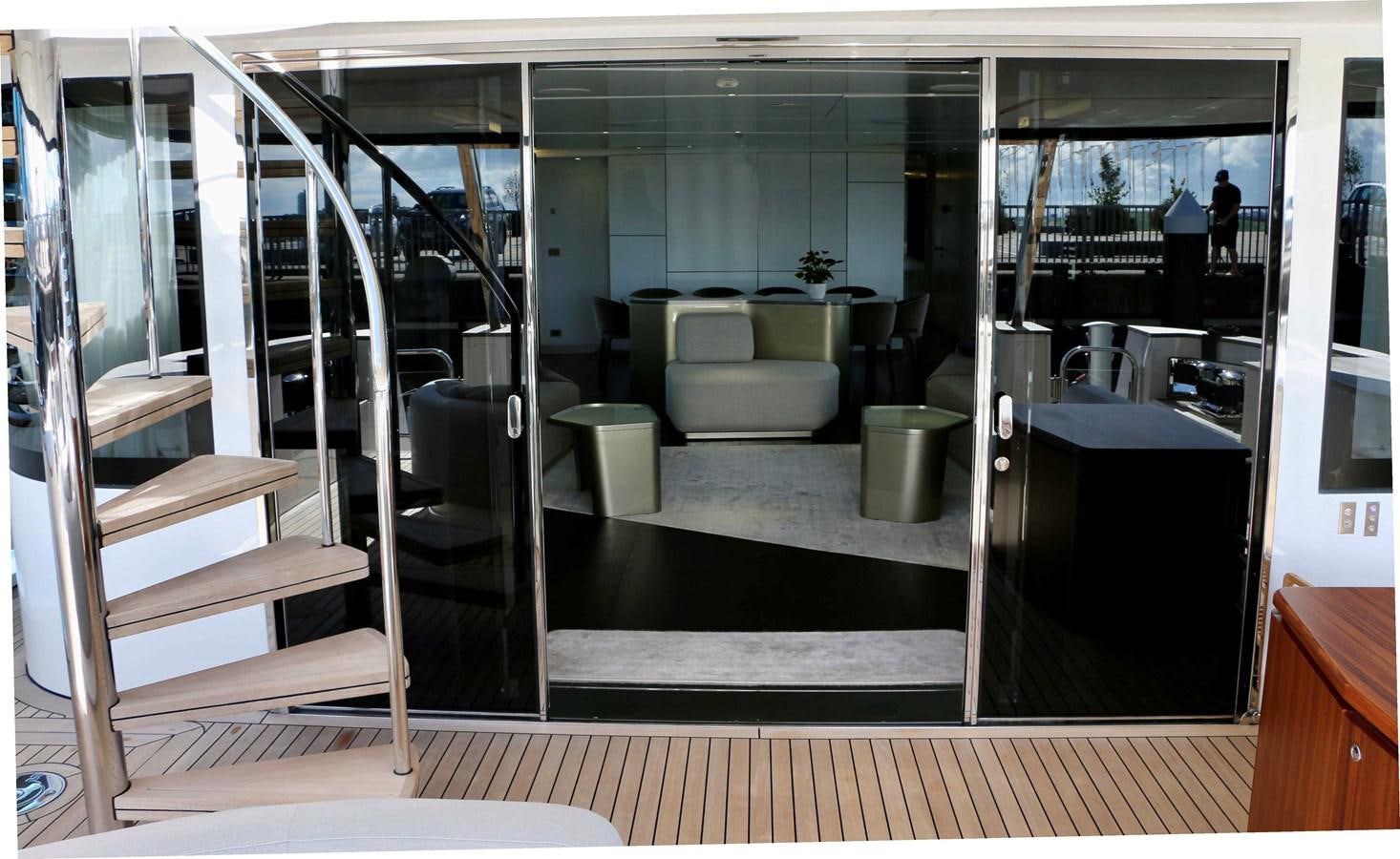 a room with glass doors aboard DB Yacht for Sale