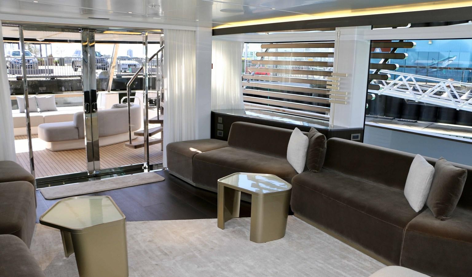 a room with couches and a table aboard DB Yacht for Sale