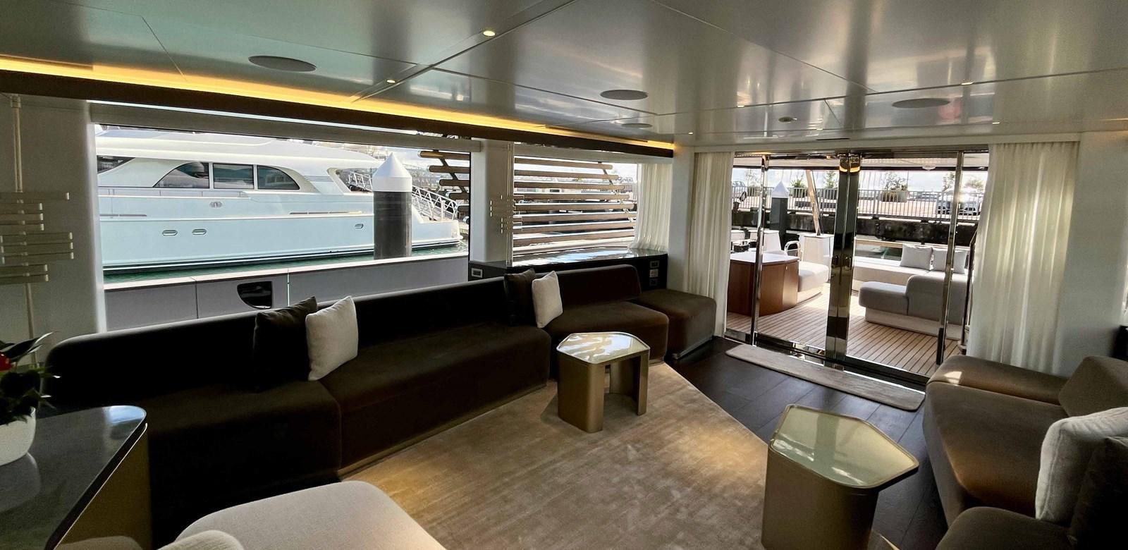a room with a couch and a table and chairs aboard DB Yacht for Sale