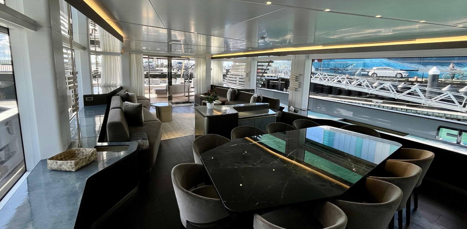 a room with a table and chairs aboard DB Yacht for Sale