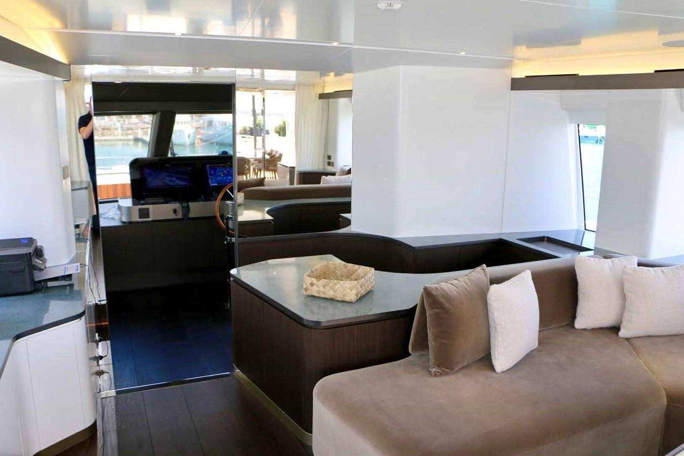 a living room with a couch and a table aboard DB Yacht for Sale