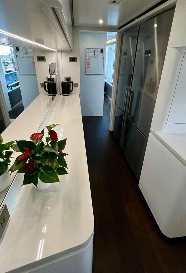a hallway with a flower pot aboard DB Yacht for Sale