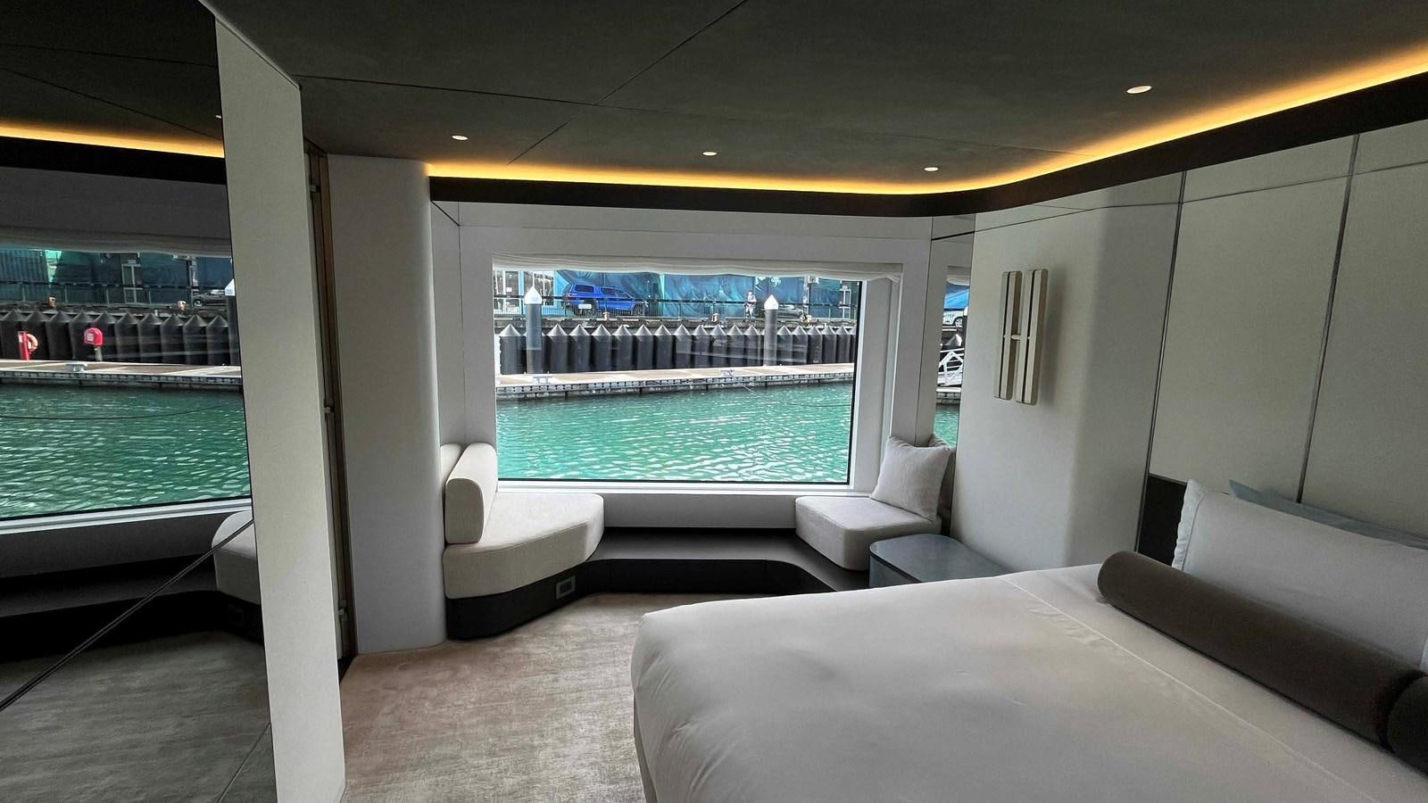 a room with a view of the water and the city aboard DB Yacht for Sale
