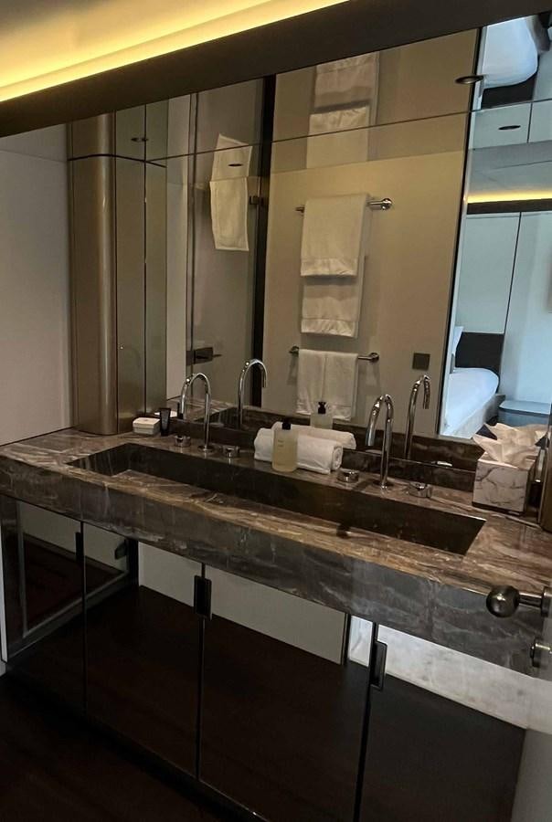 a bathroom with a large mirror aboard DB Yacht for Sale