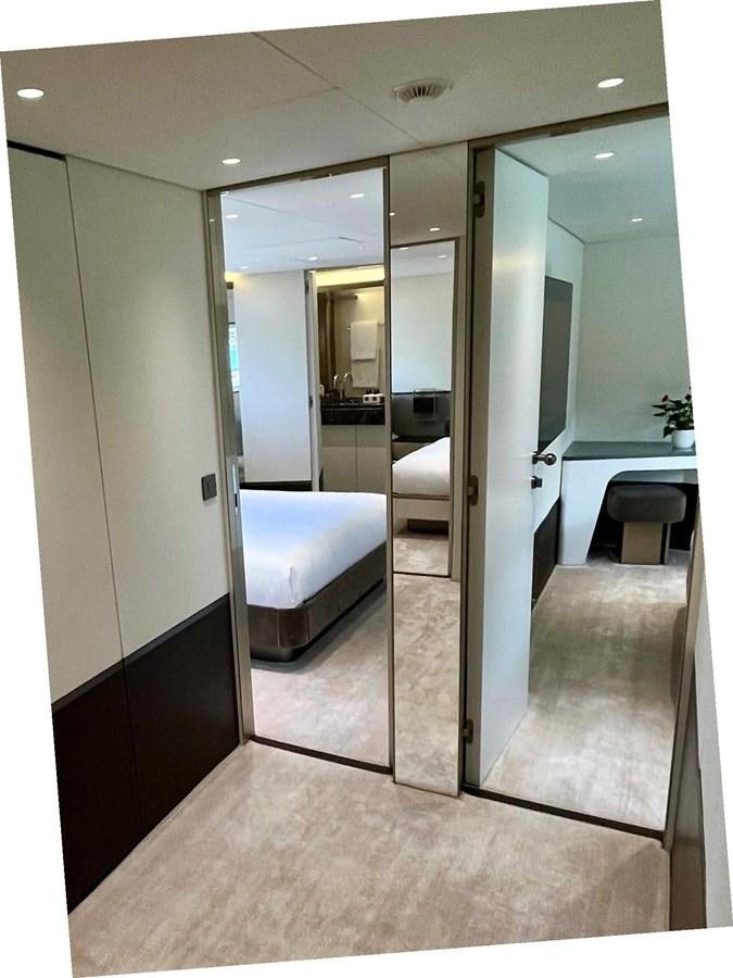 a hallway with a glass door aboard DB Yacht for Sale