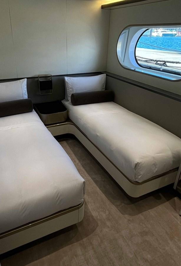 a room with a bed and a window aboard DB Yacht for Sale