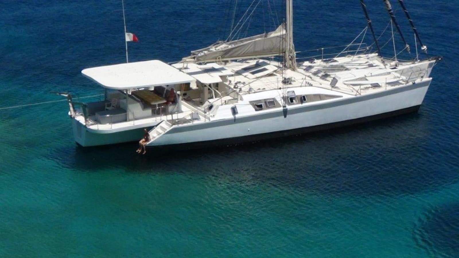 a white boat in the water aboard CONAN Yacht for Sale