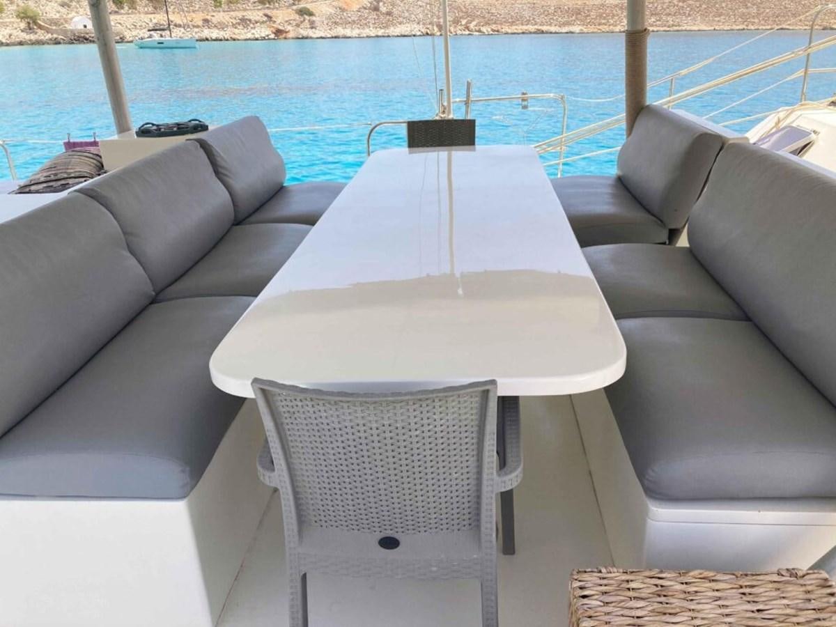 a table and chairs by a pool aboard CONAN Yacht for Sale