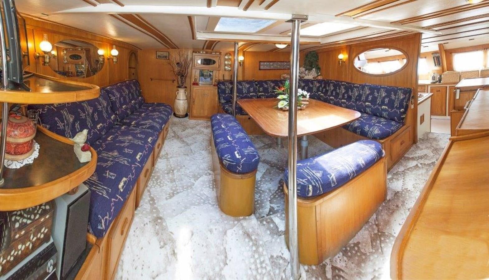 a room with a couch and a table aboard CONAN Yacht for Sale
