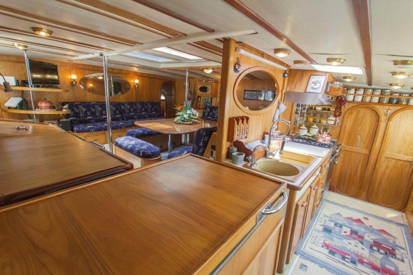 a large kitchen with a bar and bar aboard CONAN Yacht for Sale