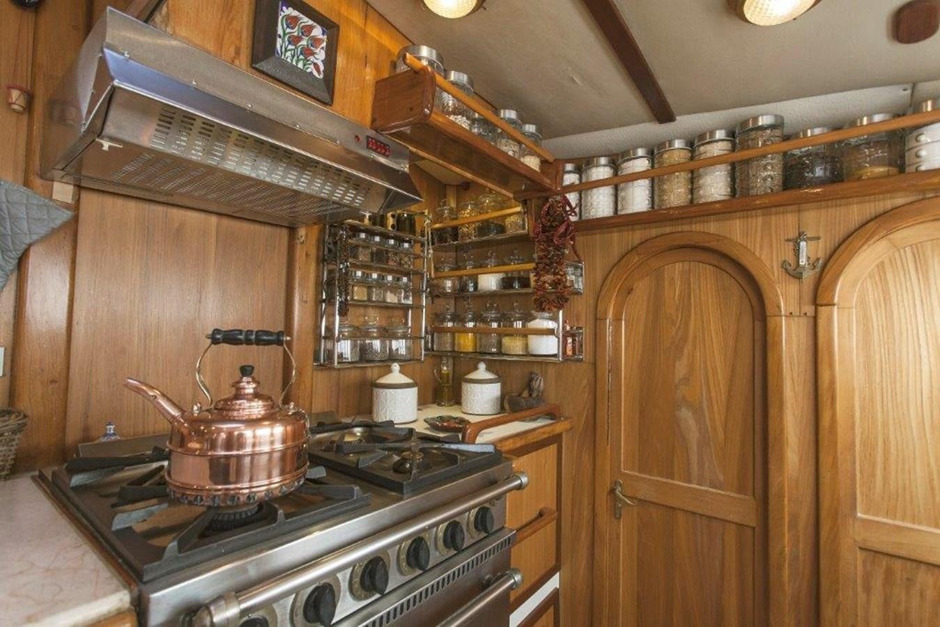 a kitchen with a tea kettle on the stove aboard CONAN Yacht for Sale