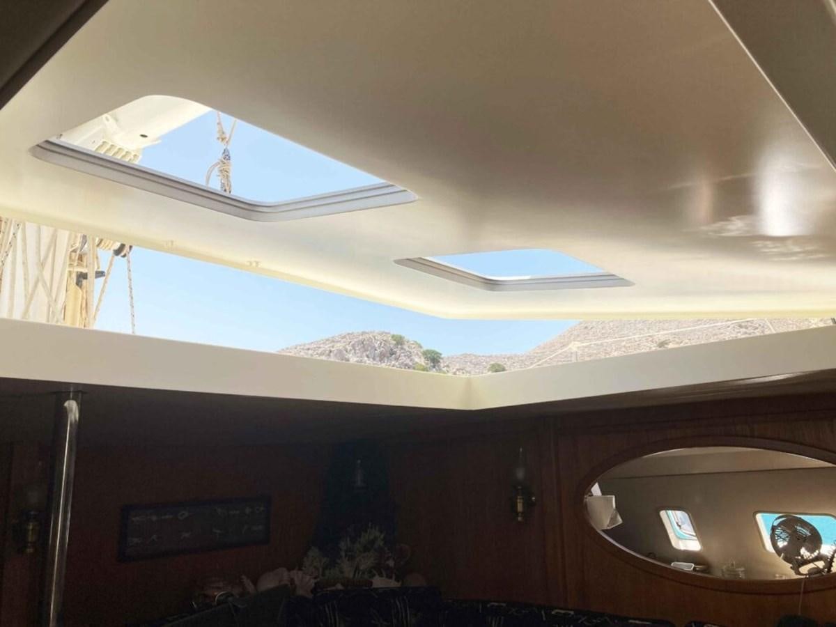 a ceiling with a window and a person on the wall aboard CONAN Yacht for Sale