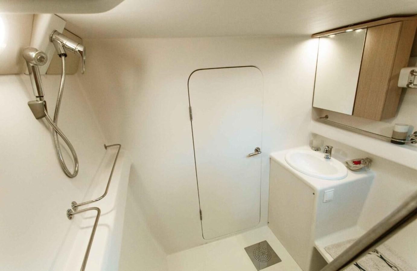 a bathroom with a sink and a mirror aboard CONAN Yacht for Sale
