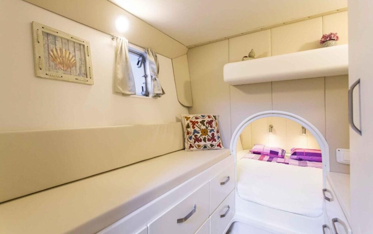 a small bedroom with a crib aboard CONAN Yacht for Sale